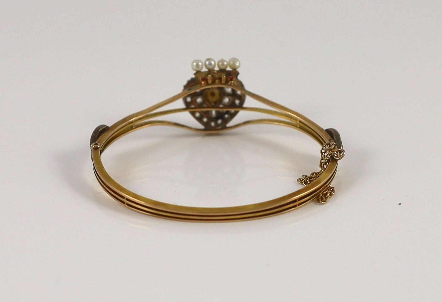 A Victorian gold, old cut diamond, ruby and split pearl set hinged bangle